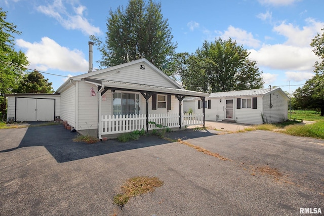 view of front of property with a storage shed and a porch