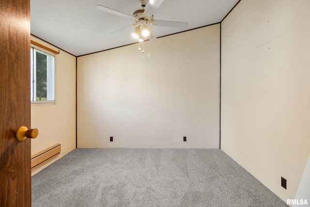 carpeted spare room with ceiling fan and a baseboard heating unit