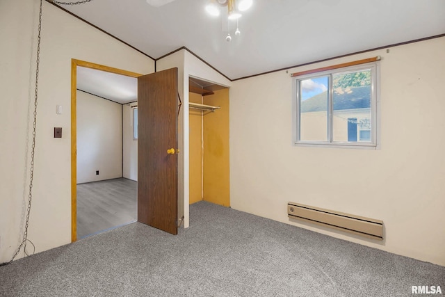 unfurnished bedroom featuring a baseboard radiator, lofted ceiling, a closet, and carpet