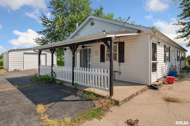 view of front of house with covered porch and an outbuilding