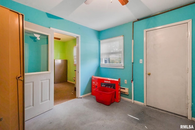 interior space featuring ceiling fan and concrete floors