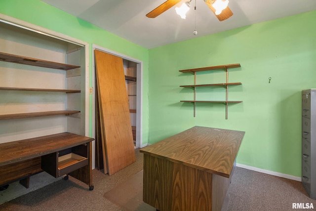 unfurnished office with ceiling fan and dark carpet