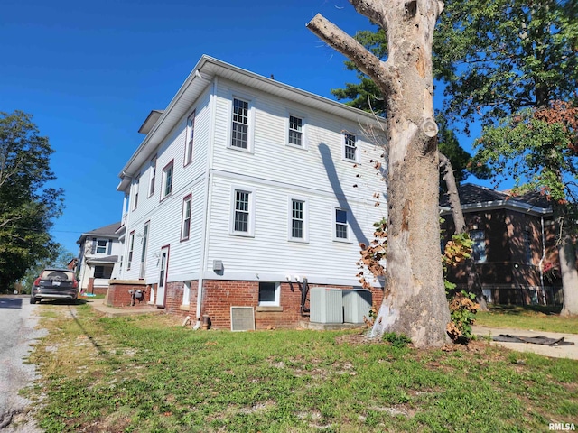 view of property exterior with a lawn