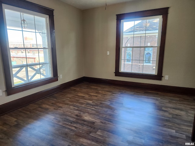 spare room with dark hardwood / wood-style flooring