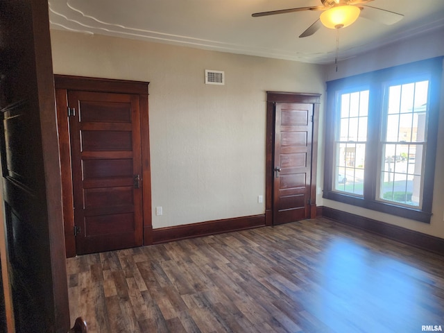 spare room with ceiling fan and dark wood-type flooring