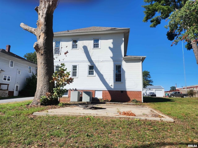 rear view of property featuring a yard