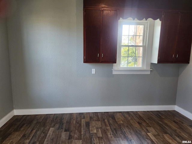 spare room featuring dark wood-type flooring