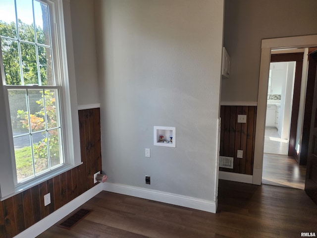 laundry area with washer hookup, wooden walls, dark wood-type flooring, and electric dryer hookup