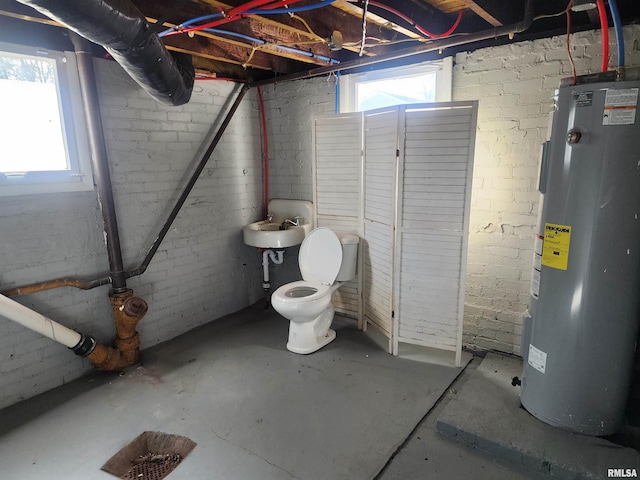 basement with water heater and sink