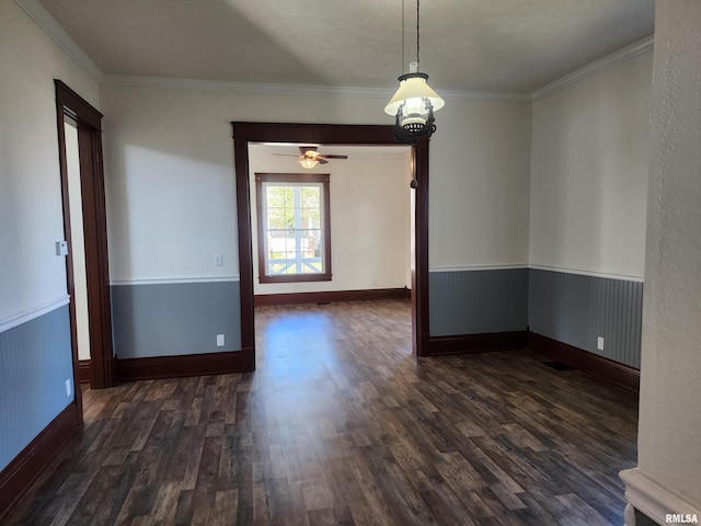 unfurnished room featuring ornamental molding, ceiling fan with notable chandelier, and dark hardwood / wood-style flooring