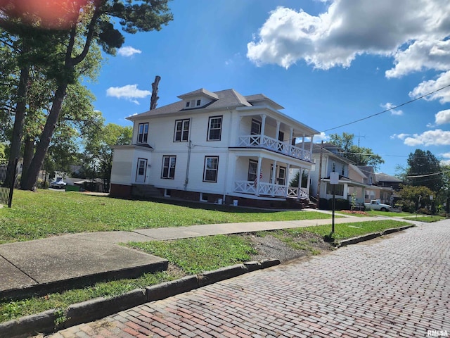 view of front of property with covered porch and a front yard