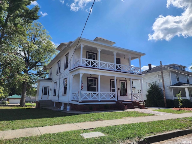 view of front of home featuring a balcony, a porch, and a front lawn