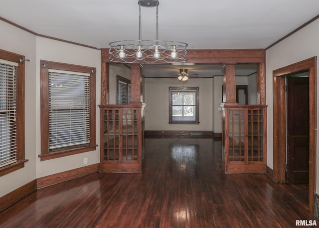 unfurnished dining area featuring dark hardwood / wood-style floors, ceiling fan, and crown molding