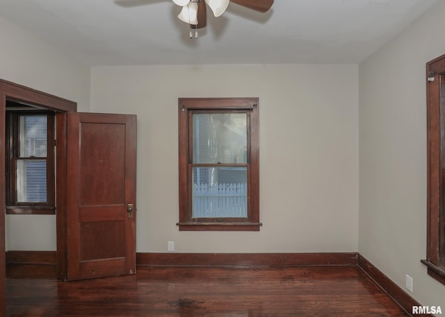 empty room featuring ceiling fan and dark hardwood / wood-style flooring