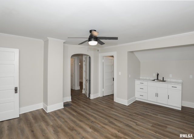 unfurnished living room with dark hardwood / wood-style flooring, ceiling fan, ornamental molding, and sink