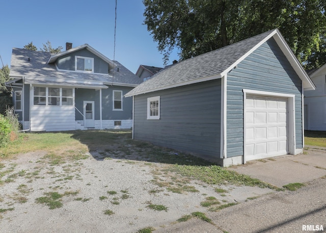 view of front facade with an outbuilding and a garage