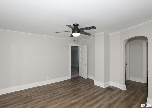 spare room featuring crown molding, ceiling fan, and dark wood-type flooring