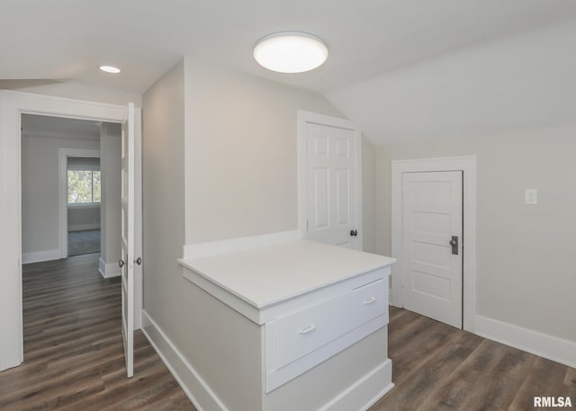 hall with dark hardwood / wood-style floors and lofted ceiling