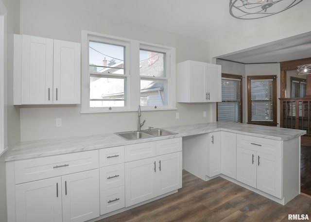 kitchen with white cabinets, dark wood-type flooring, and sink