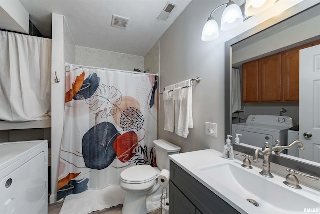 bathroom featuring separate washer and dryer, vanity, toilet, and a shower with shower curtain