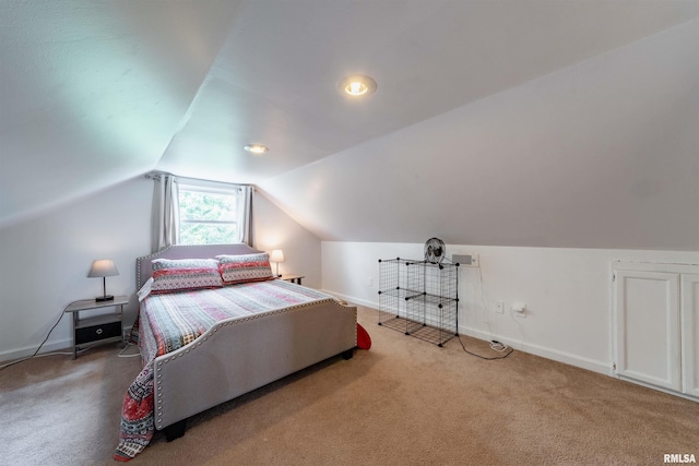 bedroom with carpet floors and vaulted ceiling