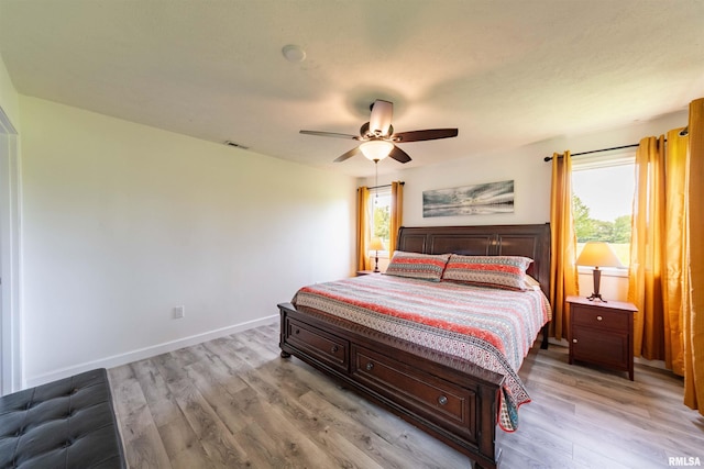 bedroom with light wood-type flooring and ceiling fan