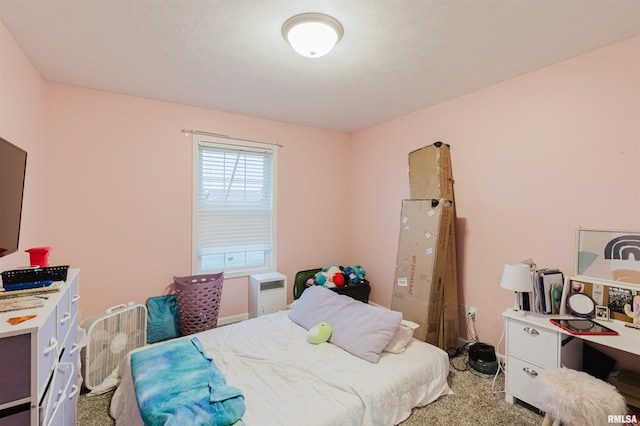 bedroom with a textured ceiling and carpet flooring