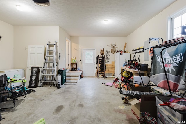 garage featuring a garage door opener and white fridge