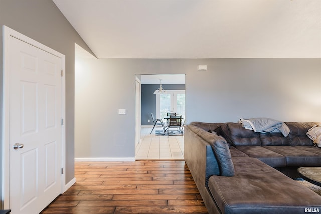 living room featuring light hardwood / wood-style floors and an inviting chandelier