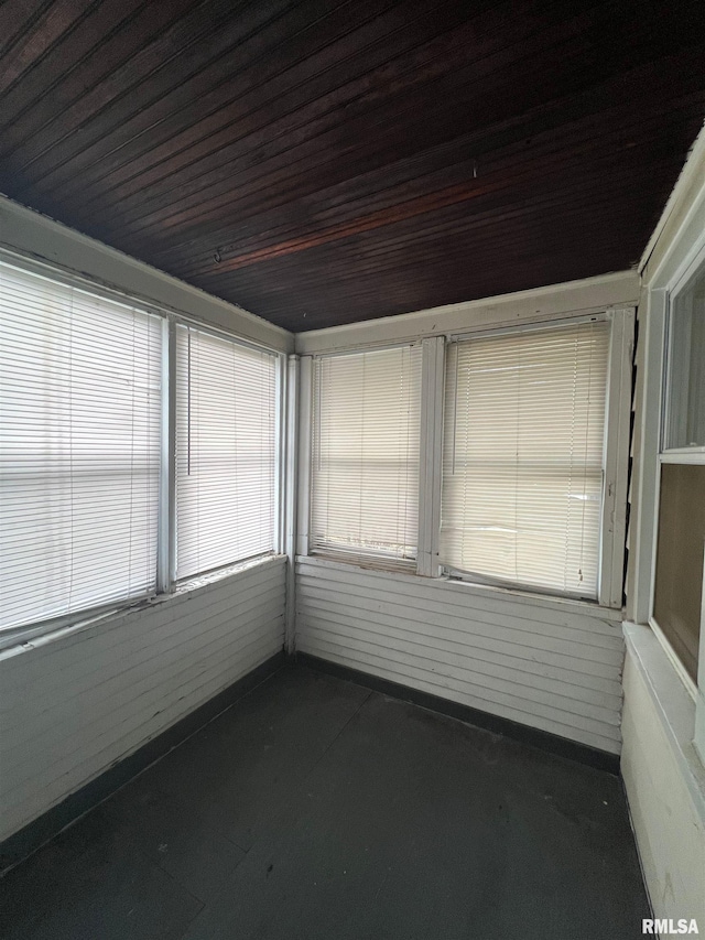 unfurnished sunroom with wooden ceiling