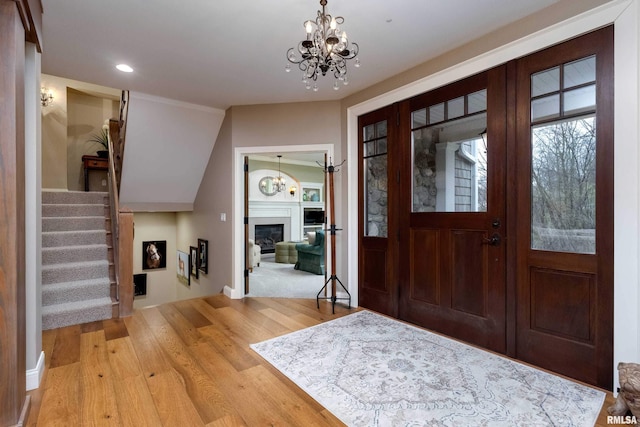 foyer with an inviting chandelier and wood-type flooring