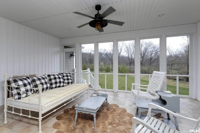 sunroom / solarium with wood ceiling and ceiling fan