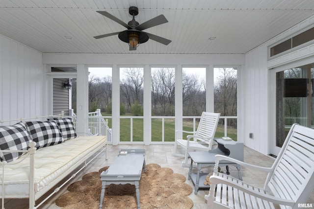 sunroom with wood ceiling and ceiling fan