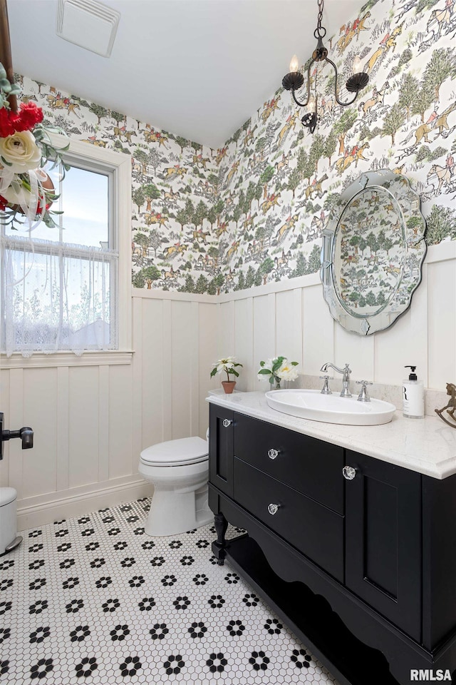 bathroom featuring toilet and vanity