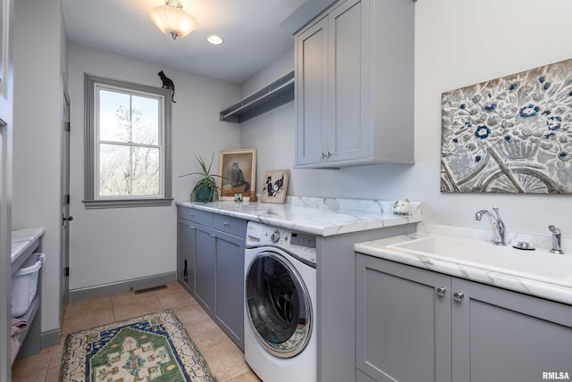 laundry room with washer / dryer, sink, light tile patterned floors, and cabinets