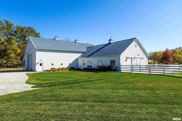 exterior space featuring a garage and a lawn