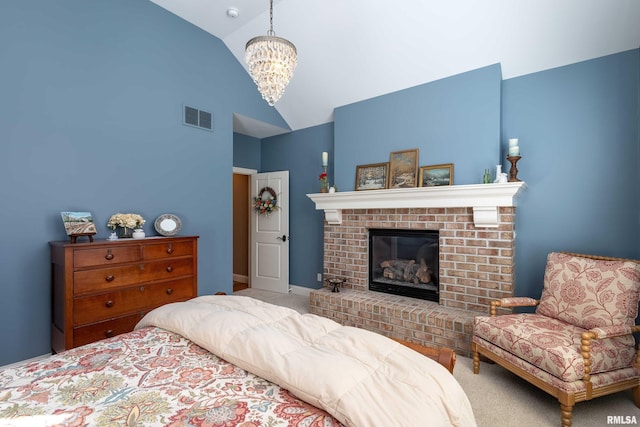 bedroom with a chandelier, carpet flooring, a fireplace, and vaulted ceiling