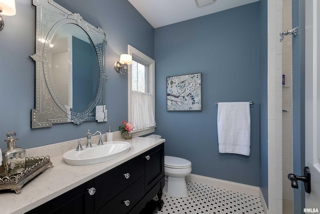 bathroom featuring walk in shower, vanity, toilet, and tile patterned flooring