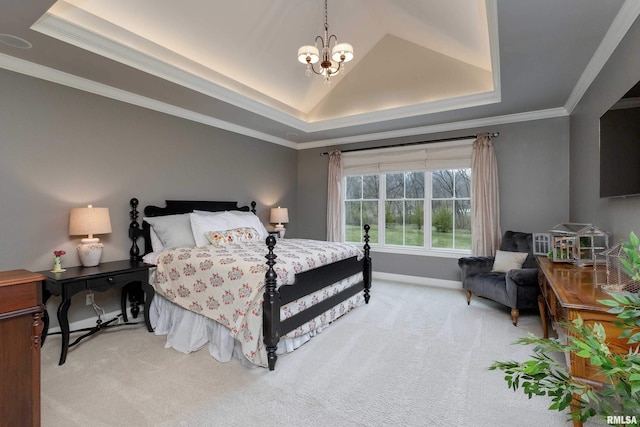 bedroom featuring ornamental molding, a tray ceiling, and carpet floors