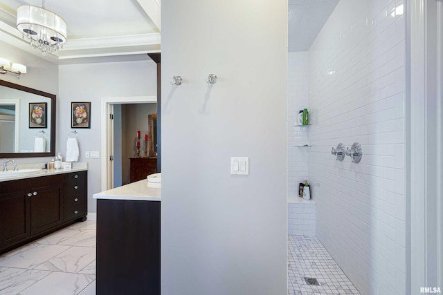 bathroom featuring vanity, a tile shower, and an inviting chandelier