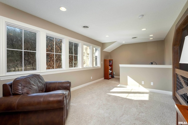 sitting room featuring light colored carpet