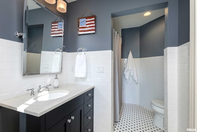 bathroom with vanity, toilet, tile walls, and a shower with curtain