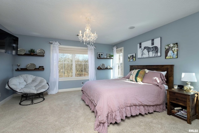 carpeted bedroom with a notable chandelier