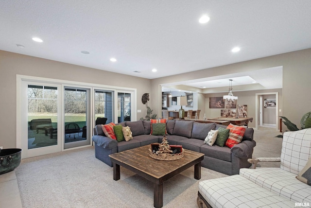 carpeted living room with a textured ceiling