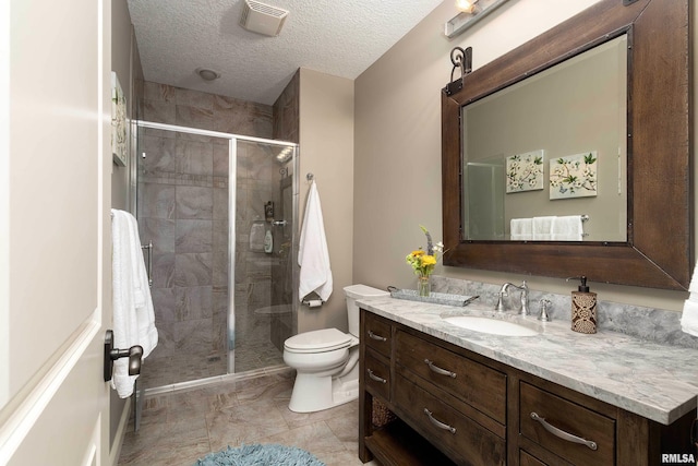 bathroom featuring vanity, a textured ceiling, toilet, and an enclosed shower