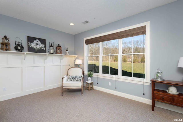 living area featuring carpet