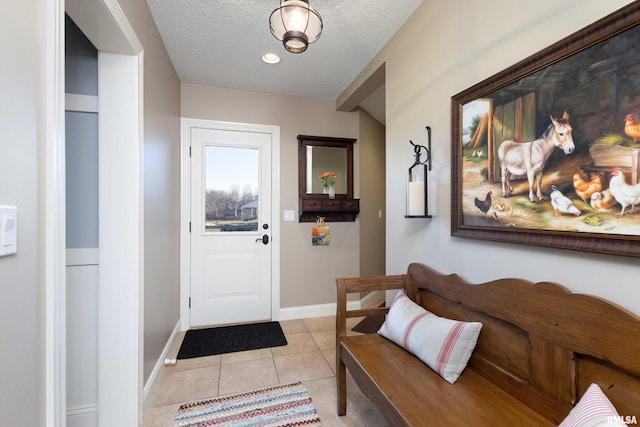 tiled foyer featuring a textured ceiling