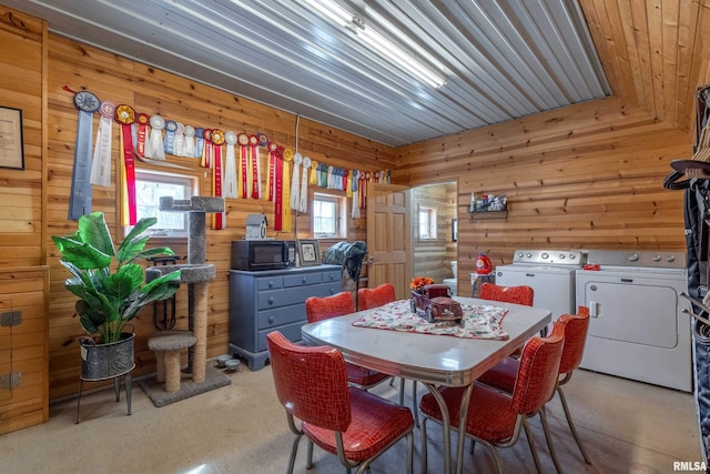 dining area with washer and dryer, a healthy amount of sunlight, light carpet, and wooden walls