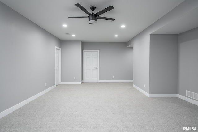 empty room featuring light carpet and ceiling fan