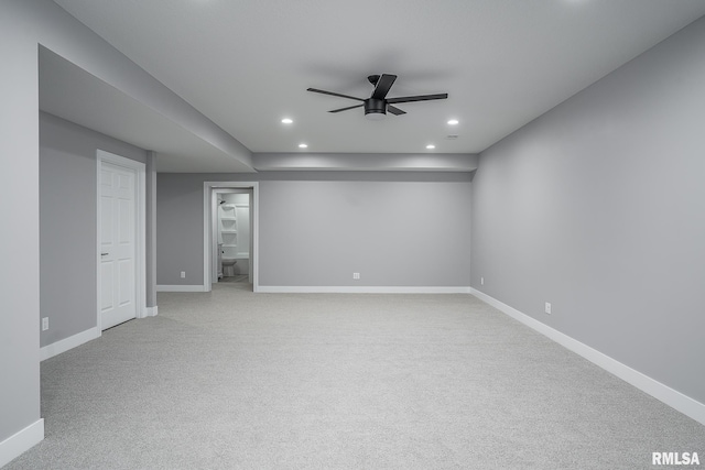 basement with light carpet and ceiling fan